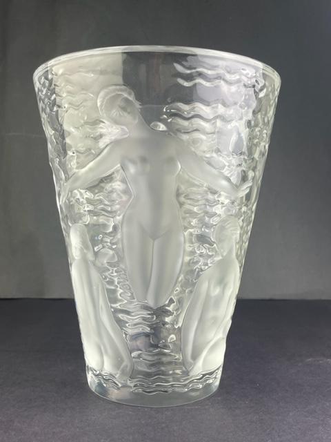 Lalique France "Ondines" crystal vase in clear and frosty glass.: Lalique France "Ondines" crystal vase in clear and frosty glass. Decorated with nude Muses and water waves all around. Signed "Lalique France" in script. Designed by Marc Lalique 1952. Height 9 1/2 in