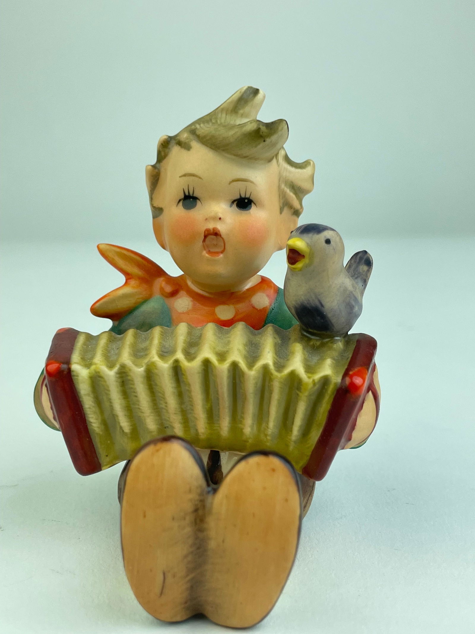 Goebel Hummel porcelain figure. West Germany: Goebel Hummel porcelain figure. West Germany.Accordian Boy.Height 3 3/8 inches.