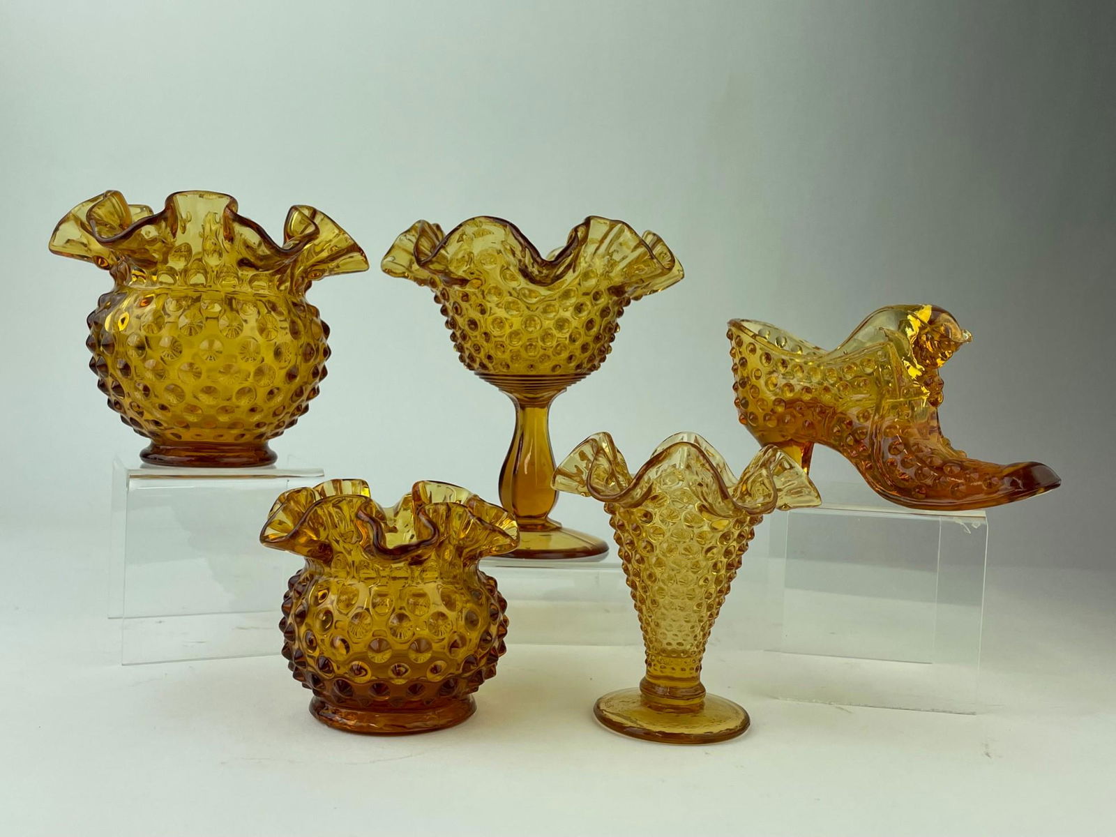 Five vintage Fenton hobnail pattern amber glass pieces,: Five vintage Fenton hobnail pattern amber glass pieces, three vases with ruffle edges tallest 4 1/4 inches, one 6 inch tall compote with ruffle edges and one 3 inch high boot.Tallest 6 inches.