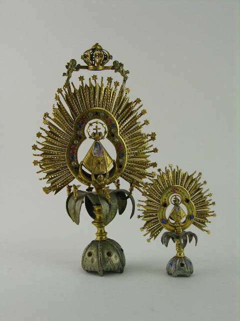 Four Spanish Colonial brass and gilt metal religious: Four Spanish Colonial brass and gilt metal religious pieces, 20th century; comprising two crowned and jeweled Madonna with Child figures and a pair of five branch candlesticks. Tallest: 9"