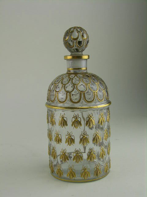 Guerlain perfume bottle decorated in the Napoleonic: Guerlain perfume bottle decoratedin the Napoleonic style with gilt bumble bees, the underside with embossed Guerlain and Made in France. H: 7 ¾"