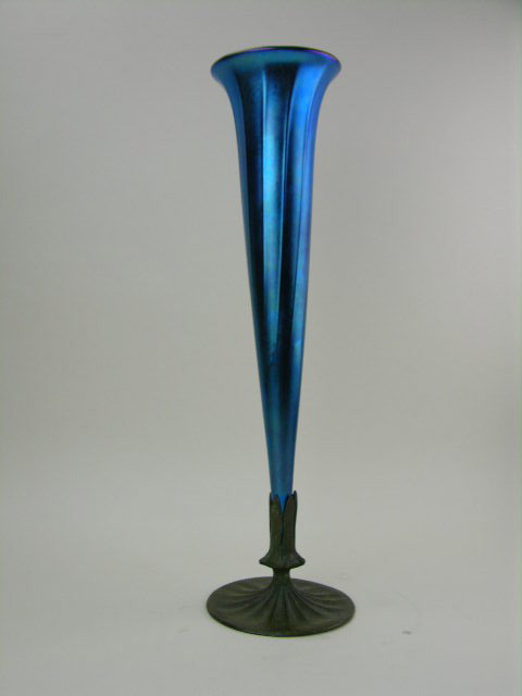 Louis Comfort Tiffany blue iridescent blue favrile : Louis Comfort Tiffany blue iridescent blue favrile art glass vase with bronze base. The bottom of the glass vase inscrbed LCT, the bronze base stamped Tiffany Studios New York810. Overall height 18 3/