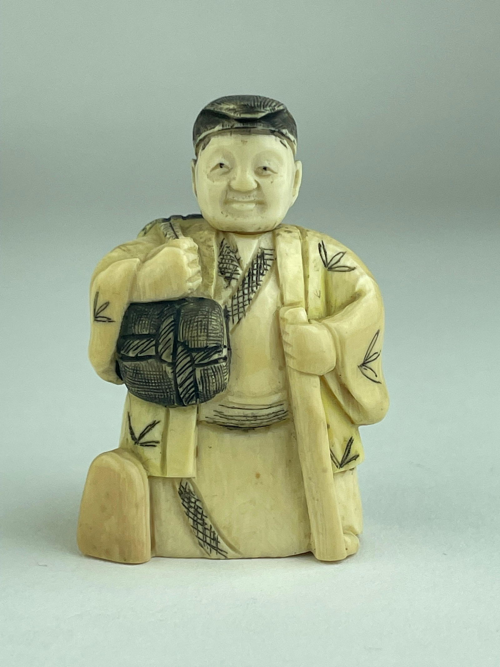 Antique Japanese carved netsuke figure of a standing man whose head can rotate. (1 of 3)