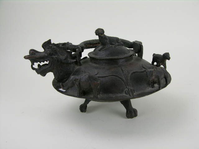 Chinese bronze teapot decorated with a dragon: Chinese bronze teapot decorated with a dragon spout and handle. H: 9" Diameter: 9"