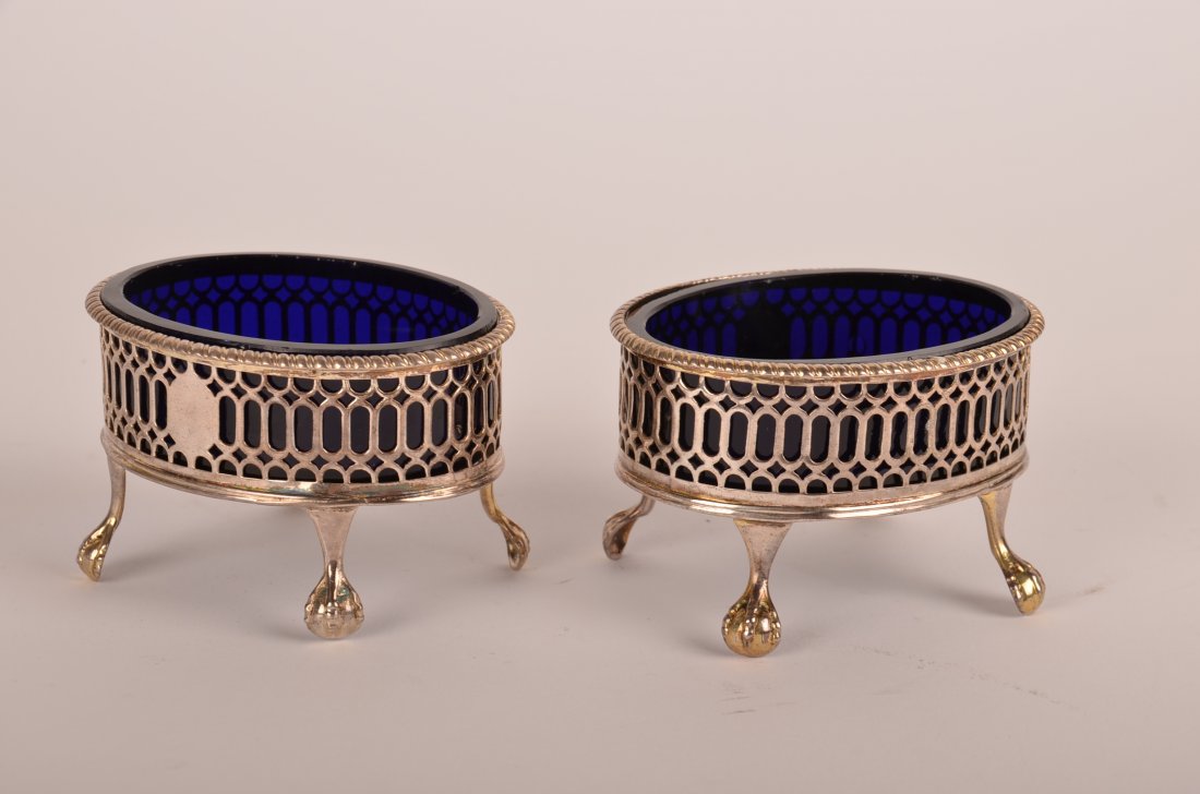 Pair of Hester Bateman George III Open Salts: Pair of Hester Bateman (1708-1794) Oval Reticulated Sterling Silver Cobalt Blue Glass-Lined Open Salts, London, 1778, each supported on claw-and-ball feet. Height: 2" Width: 3 1/4" Depth: 2 1/2"