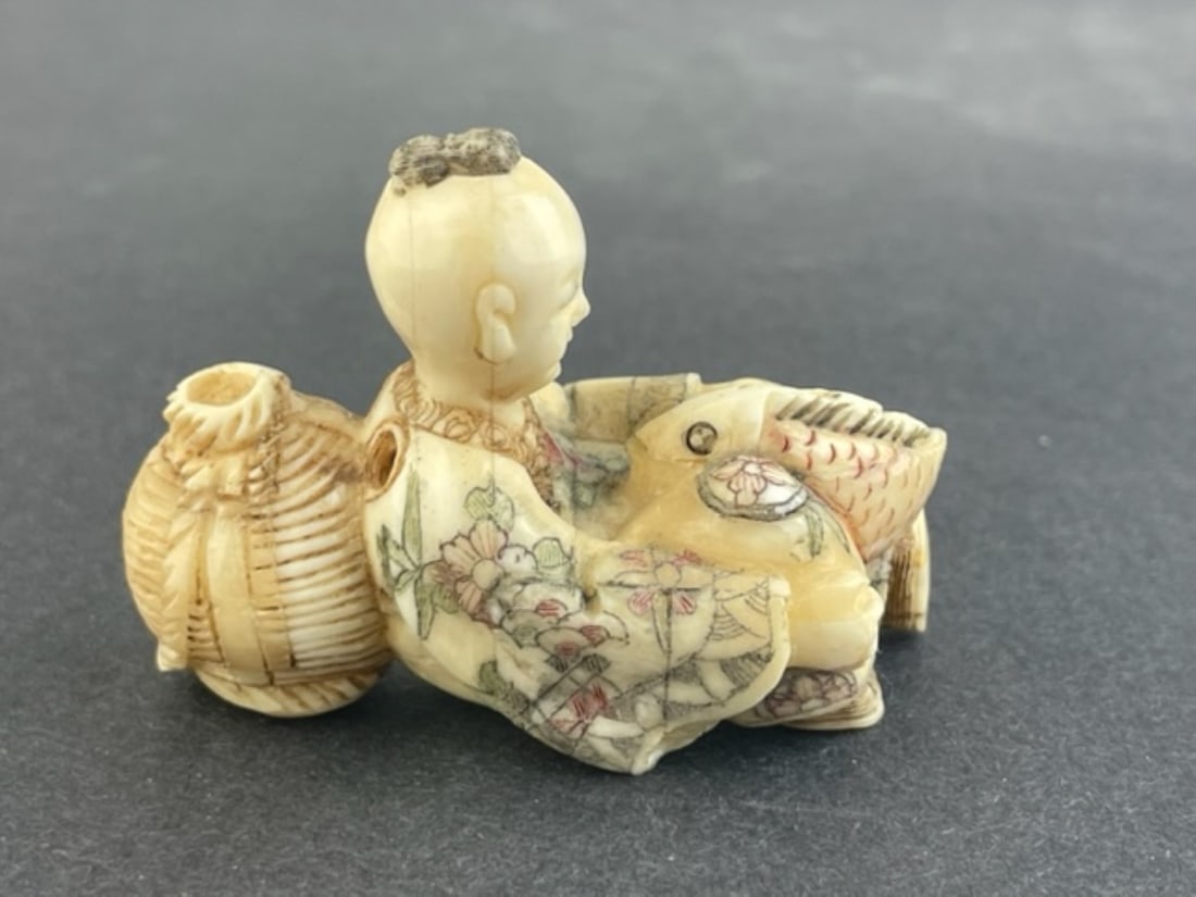 Antique Japanese carved netsuke of a seated man with a fish and basket. (1 of 5)
