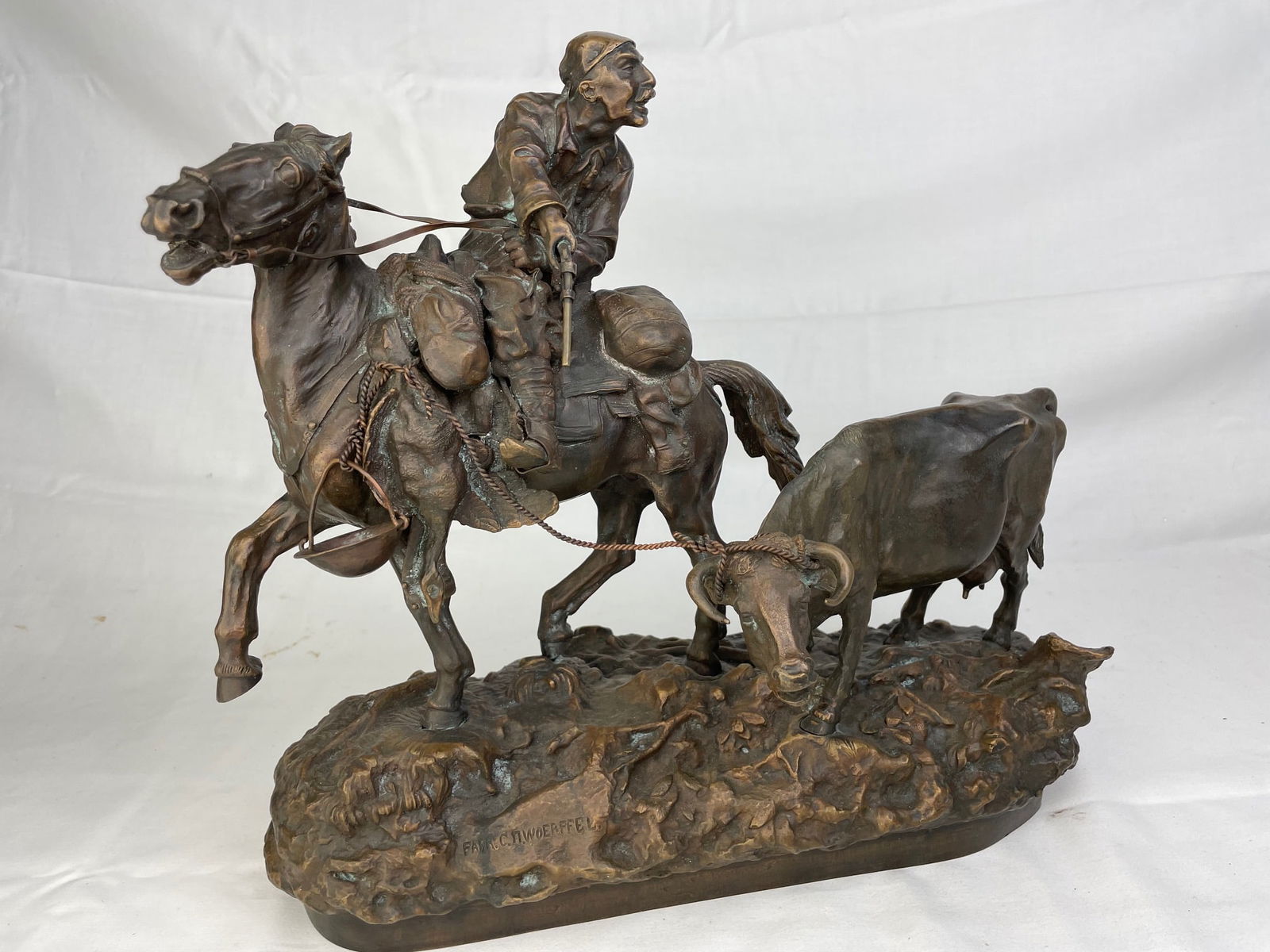 Vasilli Grachev, (Russian, 1831-1905). Cattle Thief, a bronze figure of a thief: Vasilli Grachev, (Russian, 1831-1905). Cattle Thief, a bronze figure of a thief on horse back holding a hand gun and looking back.Artist signed in Cyrillic as well as stamped with the foundry "Farr. C