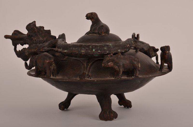 Chinese bronze teapot decorated with a dragon spou: Chinese bronze teapot decorated with a dragon spout and handle. H: 9" Diameter: 9"