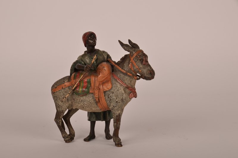 Franz Bergman (Austrian;1898-1963) cold painted bro: Franz Bergman (Austrian;1898-1963) cold painted bronze of man standing ready to ride his donkey. Stamper FB as well as numbered 3065. Height 5".
