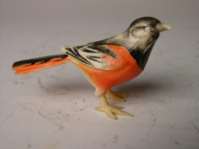 Polychrome ivory carving of a bird.: Polychrome ivory carving of a bird. (Small piece of foot missing). 1 1/2" high.