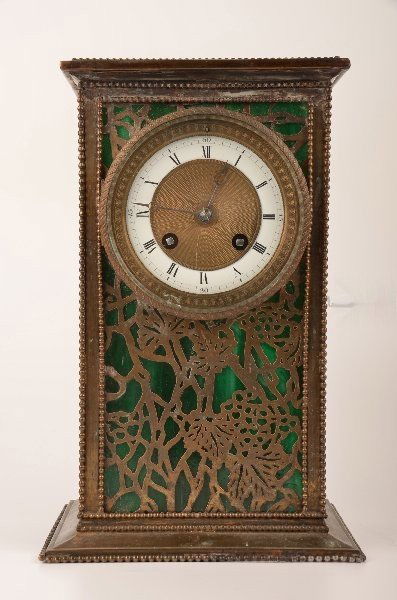 A Riviere Studios, New York, desk clock, etched metal g: A Riviere Studios, New York, desk clock, etched metal grapevine pattern over green striated glass. Unusual carriage size clock. Signed "Riviere Studios New York".Height 10 1/2". Chip to front glass,