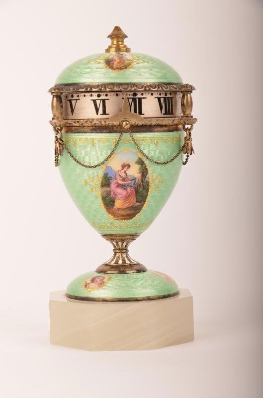 Austria, A circa 1870 Austrian, Mini Annular Dial novel: A circa 1870 Austrian, Mini Annular Dial novelty clock having light green enamel over silver, with hand painted female displays. The silver has a gentle damascene pattern that reflects through the tra