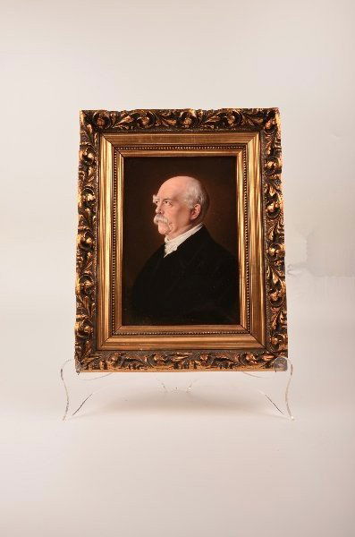 Antique pair of painted wall plaques.: Antique pair of painted wall plaques.Each plaque of a European village scene with a rectangular cartouch on a blue background with flowers and vines.