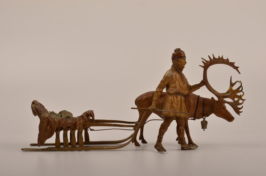 Bergman bronze figure of a fisher with his elk pulling: Bergman bronze figure of a fisher with his elk pulling a sled filled with his catch. Height 4 1/2". Length 10".