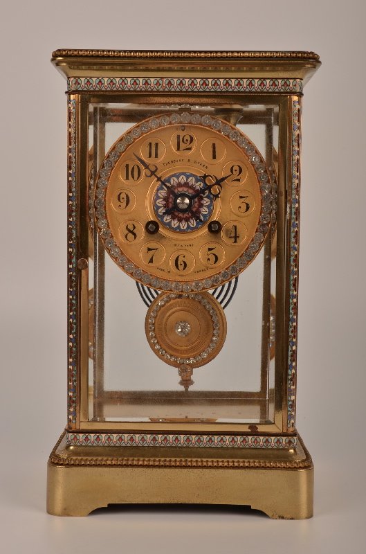 Circa 1912, Theodore Starr French crystal regulator man: Circa 1912 Theodore Starr French crystal regulator mantle clock with enamel and beveled glass with Arabic numerals and diamonetes all arount the bezel on on the pendulum. Overa1ll height 10 5/8". (The
