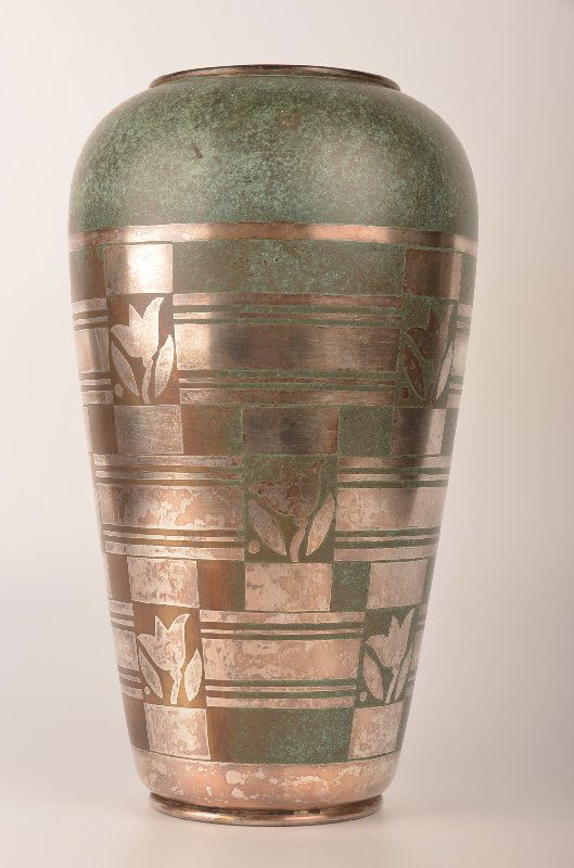 A Christofle French vase circa 1920. This footed vase w: A Christofle French vase circa 1920. This large vase with geometric pattern in the dinanderie production from Christofle. Stamped on the bottom "Christofle B 76 E".Height 13 1/8 ".