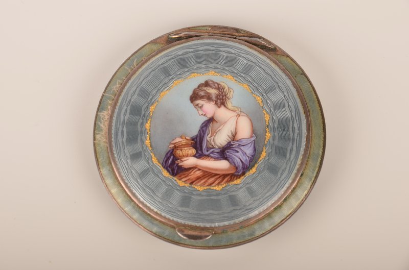 Guilloché enamelled round enamelled compact.: Guilloché enamelled round enamelled compact. A very well painted lady holding a covered urn in her hands. Diameter 2 1/2".