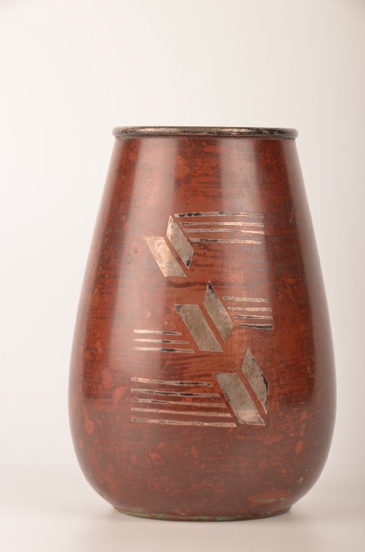 A Christofle French vase circa 1920. This vase with: A Christofle French vase circa 1920. This vase with geometric pattern in the dinanderie production from Christofle. Stamped on the bottom "Christofle B 251 G". Height 5 1/2".