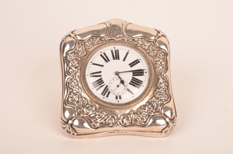 English sterling silver traveling clock.: English sterling silver traveling clock. A fine English silver cased traveling clock, Birmingham, 1903 maker, the Douglas Clock Company. The porcelain dial decorated with Roman numerals and a separate