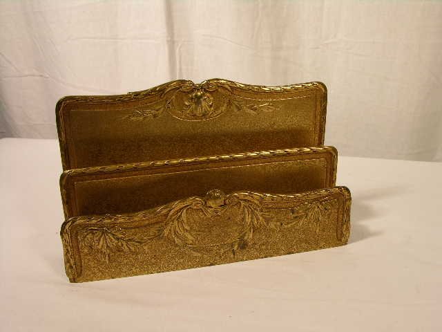 Tiffany studios paper rack in the "Louis XIV" pattern.: Tiffany studios paper rack in the "Louis XIV" pattern in its original gold dore finish. Properly marked "Tiffany Studios New York 1826". Length 9 inches. Height 5 1/4 inches. Depth 2 1/4 inches. Circa