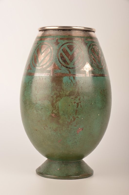 A Christofle French vase circa 1920. This footed vase: A Christofle French vase circa 1920. This footed vase with geometric pattern in the dinanderie production from Christofle. Stamped on the bottom "Christofle B 157 E".Height 10 3/8 ".