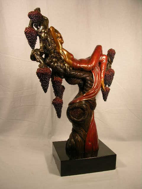 Erte bronze titled "Heat". Limited edition and: Erte bronze titled "Heat". Limited edition and documented number 197 of 375. A fine Erte bronze of a semi bare bronze woman resting in a tree with bunches of grapes. Dominate patinas of red, purple an