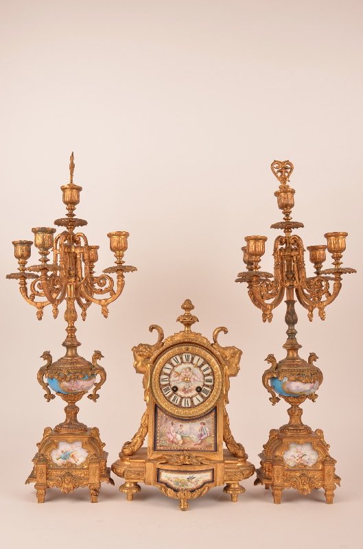 Three piece clock garniture set.: Three piece clock garniture set.Four light side pieces measures 22 inches high.The clock measures 13 inches.