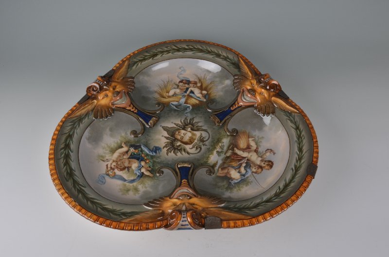 A large 18 1/2 inch KPM glazed ceramic charger. Marked: A large 18 1/2 inch KPM glazed ceramic charger.