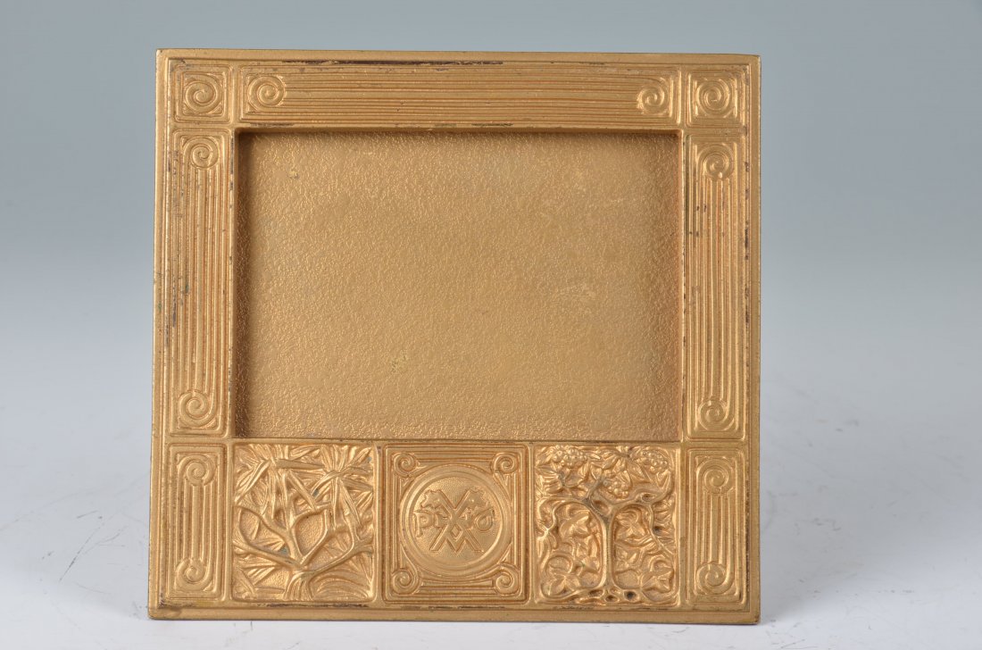 TIFFANY STUDIOS "BOOKMARK" CALENDAR FRAME.: TIFFANY STUDIOS BOOKMARK CALENDAR FRAME. Lovely Tiffany Studios calendar frame is impressed with Bookmark pattern and finished in gold patina. Frame is complete with easel back. Signed on the reverse 