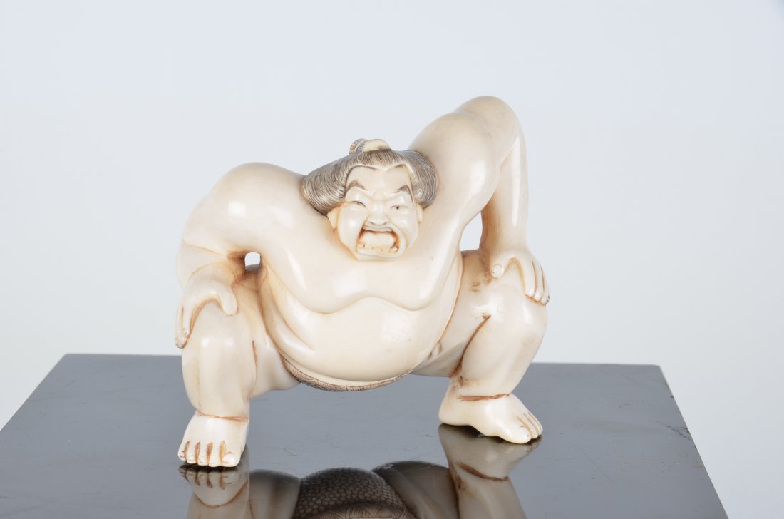 Carved figure of a wrester. Signed in red. Height 3 (1 of 4)