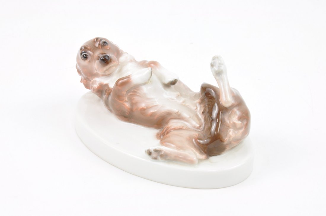 Porcelain figurine of a dog on his back. (1 of 3)