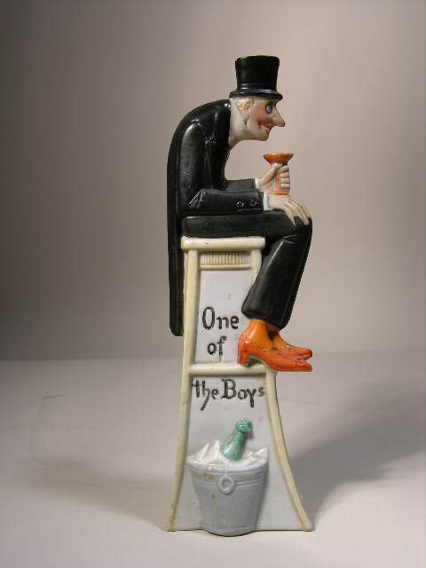 Shafer and Vater (German) figurine of a man with a top: Shafer and Vater (German) figurine of a man with a top hat drinking a cocktail while sitting on a bench with a ice bucket on the ground.Height 7". Circa 1920._x000D_