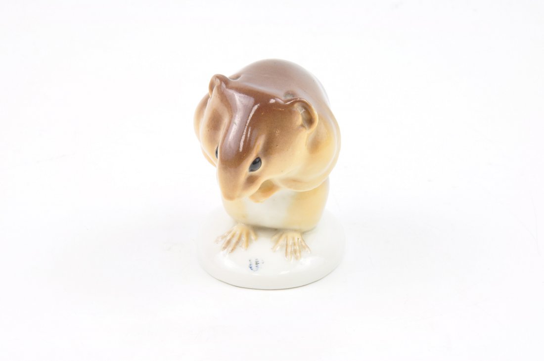 Nymphenburg German porcelain figurine of a Squirrel: Nymphenburg German porcelain figurine of a Squirrel eating. Marked with the Nymphenburg logo as well as the impressed number 542. Height 2 5/8 inches.