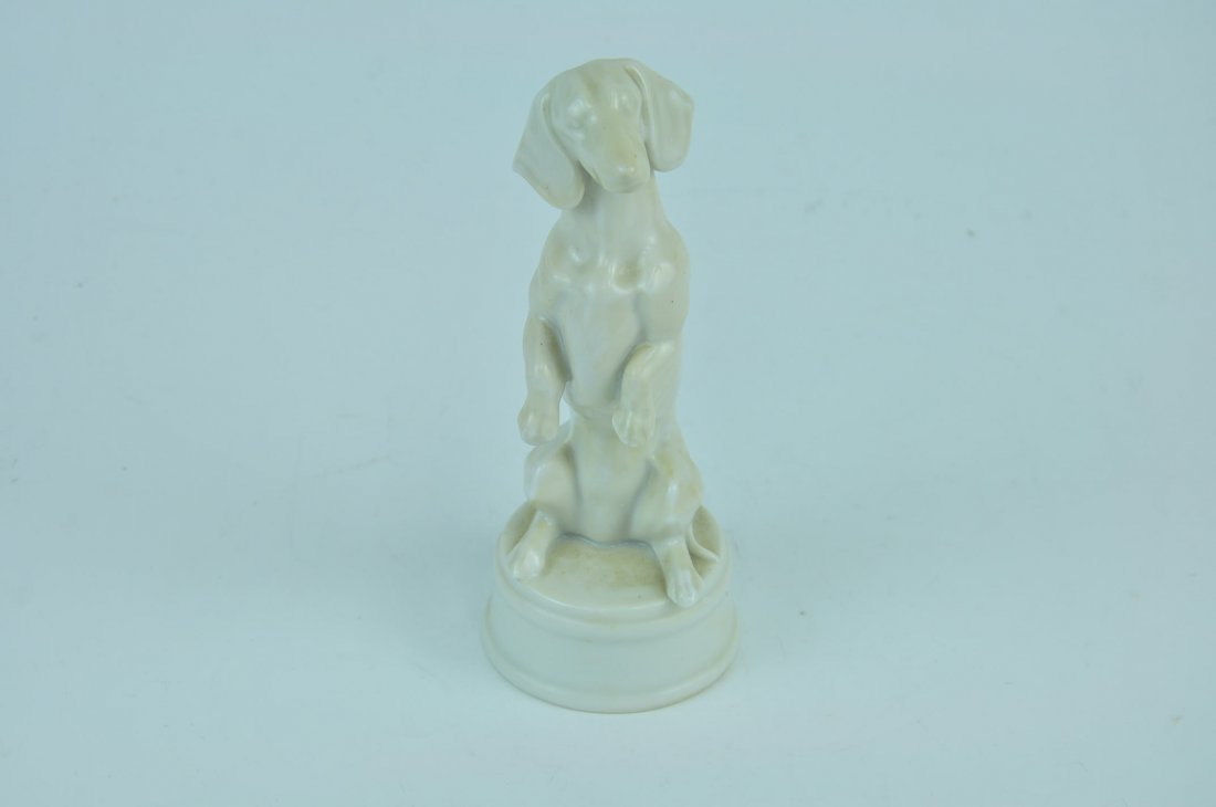 Porcelain figurine of a porcelain Dachshund standing on (1 of 3)