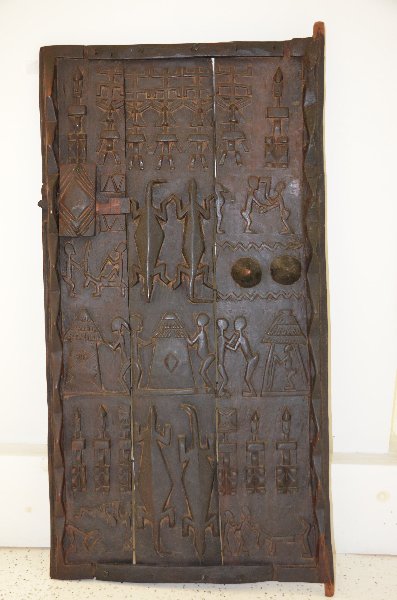 19 th century African craved grain door. 25 inches x 51: 19 th century African craved grain door. 25 inches x 51 inches.