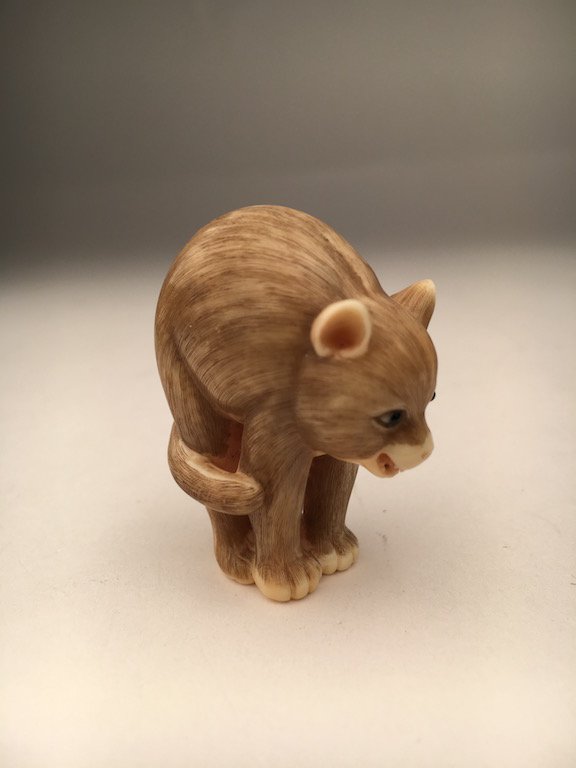A carved Netsuke figure of a cat on all four paws. (1 of 3)