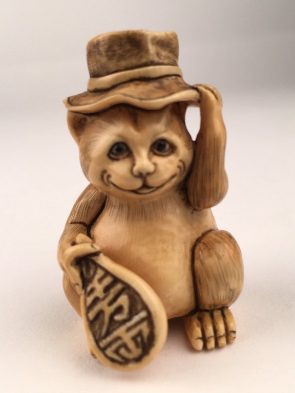 Carved Netsuke figure of a cat with a hat. (1 of 5)