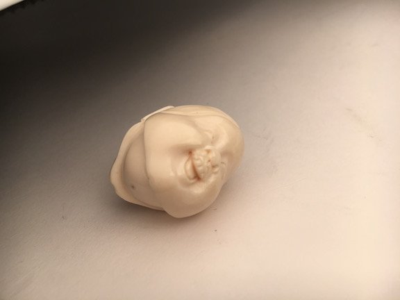 Carved Netsuke figure of a two sided face, one side of (1 of 3)