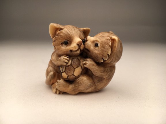 Carved Netsuke figure of a two kittens playing with a (1 of 3)