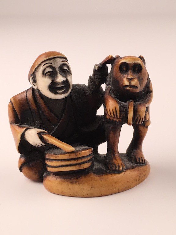 Carved Japanese Netsuke figure of a man and monkey with (1 of 5)
