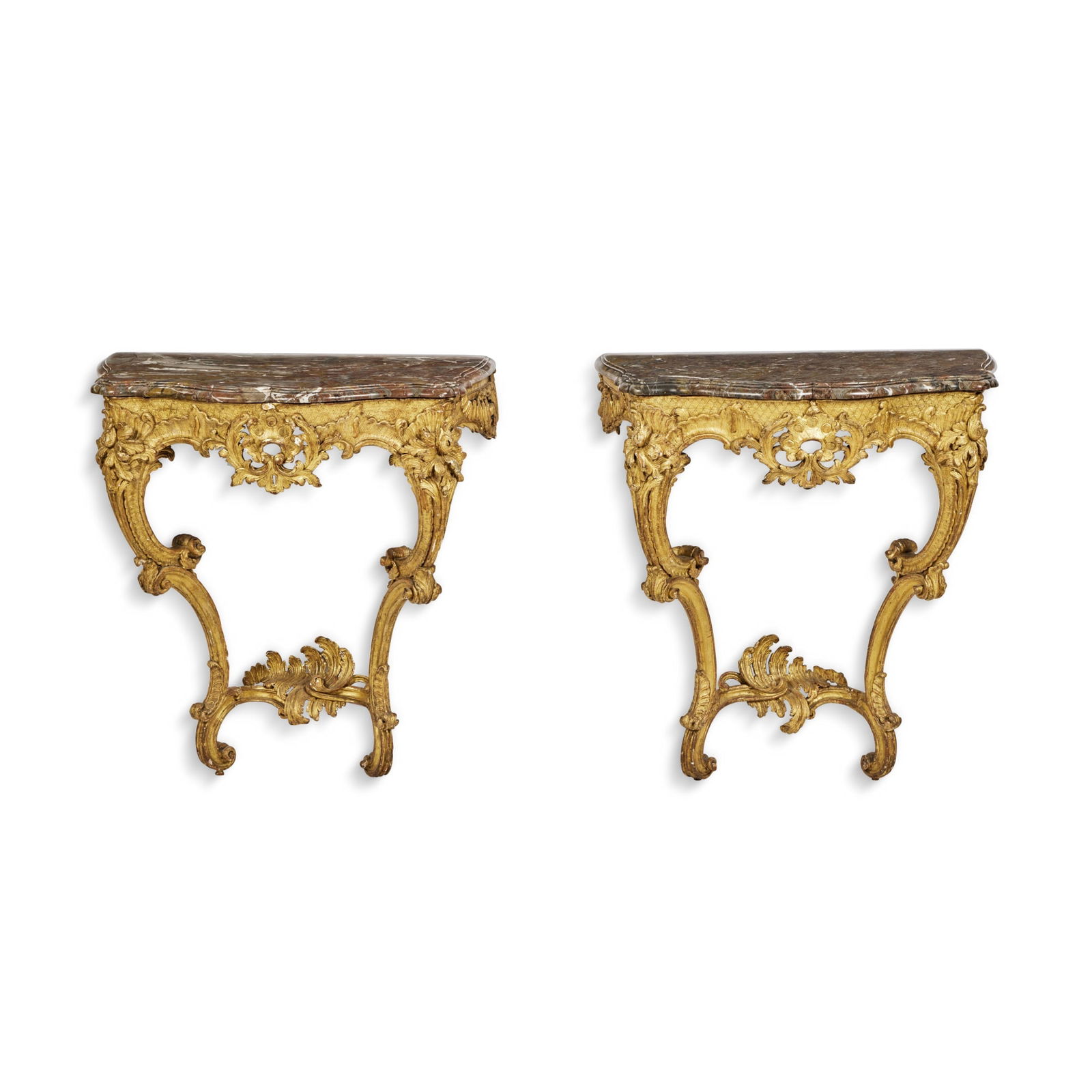 A Pair of Louis XV Carved Giltwood Console Tables, Mid-18th Century: A Pair of Louis XV Carved Giltwood Console Tables, Mid-18th Century with marble tops height 30 ½ in.; width 28 in.; depth 17 in. 77 cm; 71 cm; 43 cm Provenance Christie's, New York, November 4, 1