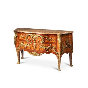 A Louis XV gilt-bronze mounted bloodwood and tulipwood veneered commode "à palmes croisées: A Louis XV gilt-bronze bracket clock, signed St Germain circa 1750 topped by a Diana figure and with putti, the mount signed SM and ST GERMAIN, the dial