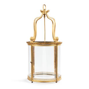 A Louis XVI style gilt-bronze and glass lantern | Lanterne en bronze doré et verre de style: A Louis XVI style gilt-bronze and glass lantern | Lanterne en bronze doré et verre de style Louis XVI A Louis XVI style gilt-bronze and glass lantern Height. 35 in 