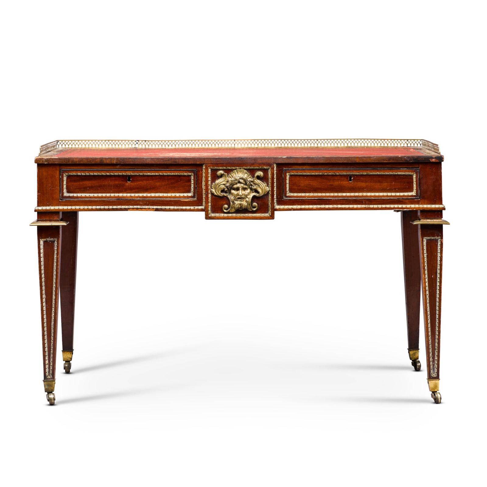 A Regency brass-mounted and mahogany library desk, circa 1815, in the manner of John Mclean: Property of a Lady of Title A Regency brass-mounted and mahogany library desk, circa 1815, in the manner of John Mclean the top with a pierced three-quarter gallery with a later gilt-tooled red leathe
