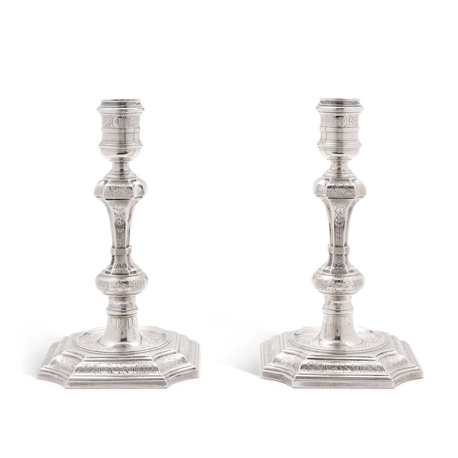 A Pair Of George II Silver Candlesticks, John White, London, 1734: Property from the Estate of Jimmy Younger (lots 23-41) Of heavy gauge, shaped square bases and stems, engraved throughout with shells, flowerheads, and diaper within strapwork, marked on bases and eng