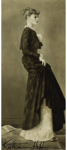 A Signed Photograph of a Painting by Alexander Bro: "A Signed Photograph of a Painting by Alexander Brook Depicting a young Katharine Hepburn dressed in period clothing, signed at bottom in black ink Katharine Hepburn, together with an identical photog