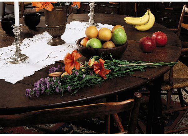 A GEORGE III PROVINCIAL OAK DROP-LEAF DINING TABLE: A GEORGE III PROVINCIAL OAK DROP-LEAF DINING TABLE, SECOND HALF 18TH CENTURY The oval top above a plain apron with a frieze drawer at one end, raised on block-and-turned gate legs joined by box stretc