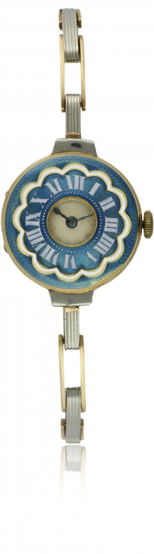 A LADIES 18K SOLID TWO COLOUR GOLD & ENAMEL BRACELET: A LADIES 18K SOLID TWO COLOUR GOLD & ENAMEL BRACELET WATCH CIRCA 1920s D: Silver dial. M: Swiss 15 jewel manual wind movement. C: Half hunter style case with blue enamel & Roman numeral hour markers,