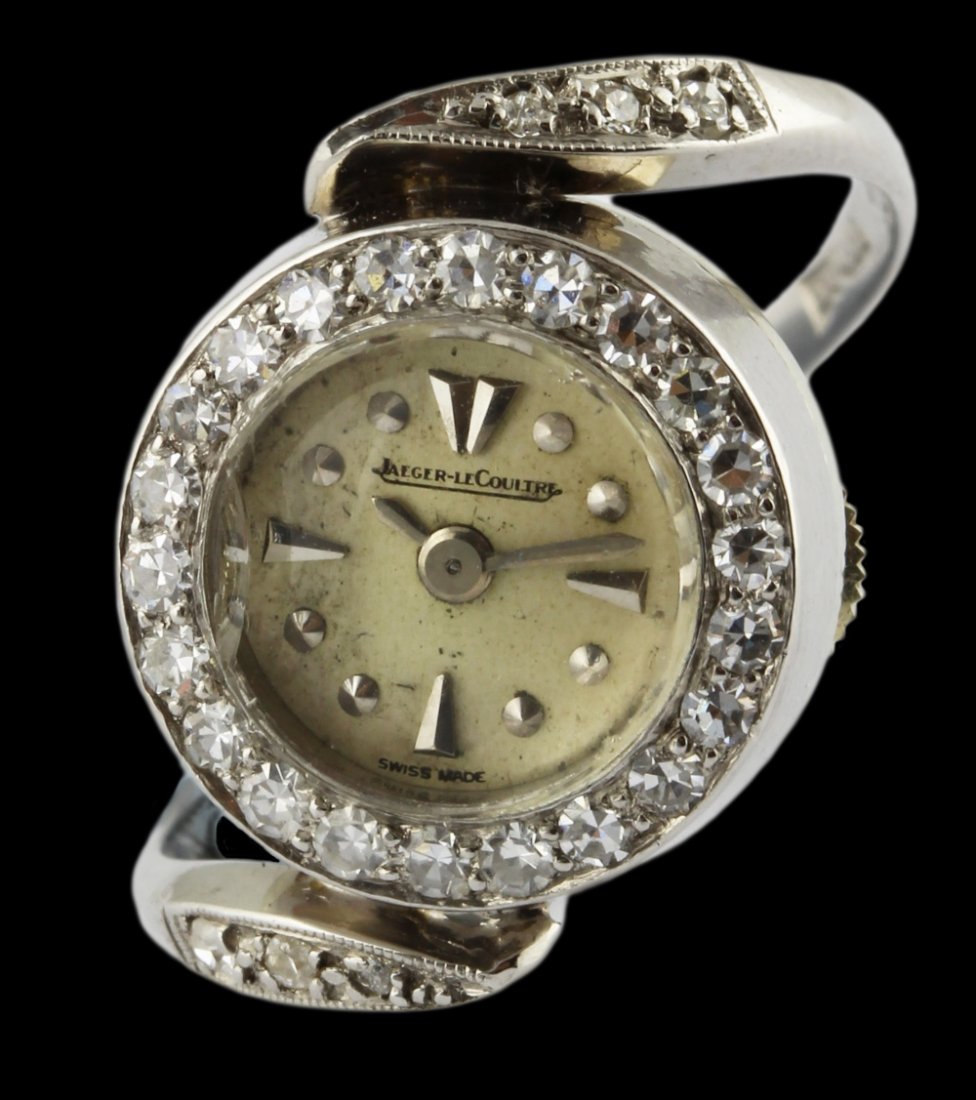 A RARE LADIES 18K SOLID WHITE GOLD & DIAMOND JAEGER: A RARE LADIES 18K SOLID WHITE GOLD & DIAMOND JAEGER LECOULTRE RING WATCH CIRCA 1950s D: Silver dial with raised silver hour markers. M: Back wind manual movement signed Jaeger LeCoultre. C: Circular c