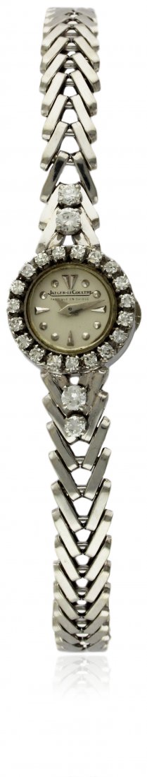 A FINE LADIES 18K SOLID WHITE GOLD & DIAMOND JAEGER: A FINE LADIES 18K SOLID WHITE GOLD & DIAMOND JAEGER LECOULTRE BRACELET WATCH CIRCA 1950s D: Silver dial with raised silver markers. M: Manual back wind movement signed Jaeger-LeCoultre. C: Circular ca